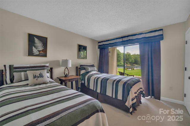 55 Toxaway Shrs Unit 14, Lake Toxaway, NC 28747 - bedroom featuring a textured ceiling, carpet floors, and access to exterior