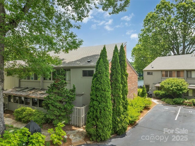 55 Toxaway Shrs Unit 14, Lake Toxaway, NC 28747 - view of property exterior with roof with shingles and uncovered parking