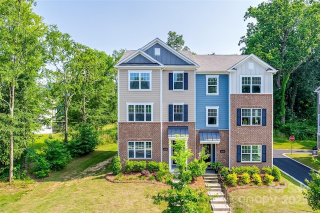 12024 John Newton Dr, Davidson, NC 28036 - view of front facade featuring board and batten siding, brick siding, and a front yard