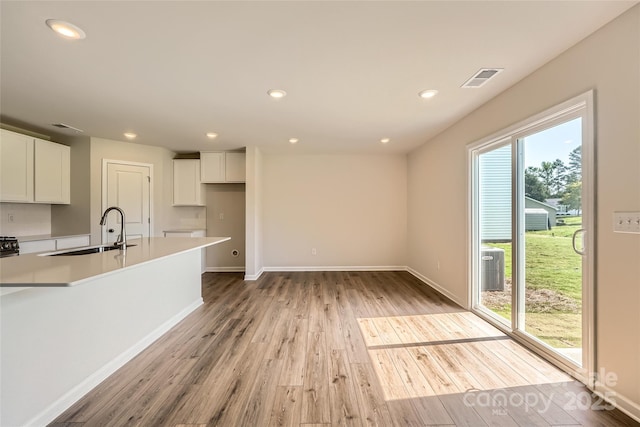 2118 Columbidae Ln, Gastonia, NC 28052 - kitchen with light wood-style floors, white cabinets, light countertops, and recessed lighting