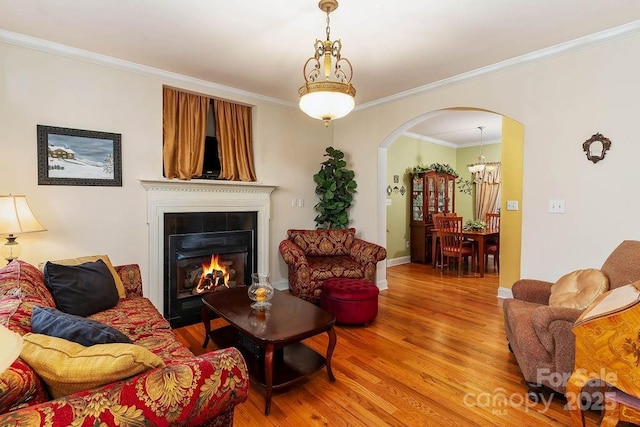 387 Goodview Dr, Hendersonville, NC 28792 - living room with arched walkways, light wood finished floors, ornamental molding, and a large fireplace