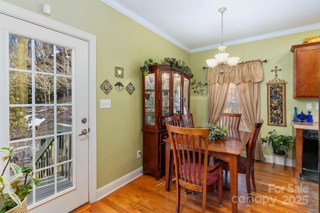 387 Goodview Dr, Hendersonville, NC 28792 - dining space featuring a chandelier, light wood-style flooring, and crown molding