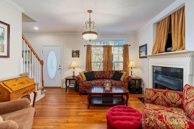 387 Goodview Dr, Hendersonville, NC 28792 - living room with stairs, wood finished floors, crown molding, a lit fireplace, and recessed lighting