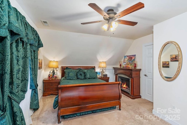 387 Goodview Dr, Hendersonville, NC 28792 - carpeted bedroom with a lit fireplace, ceiling fan, and vaulted ceiling