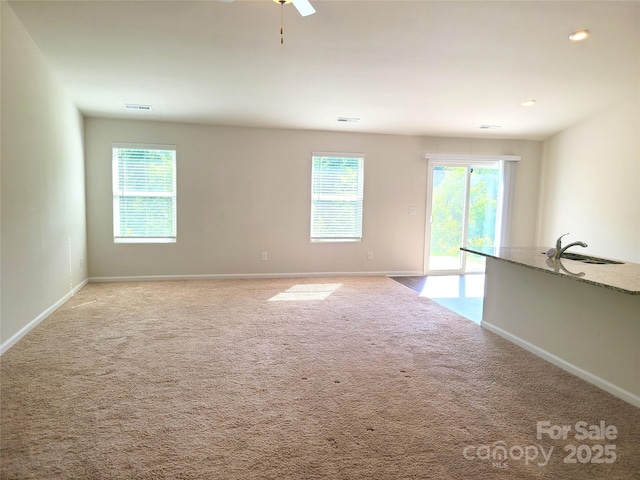 1195 Winding Creek Rd, Salisbury, NC 28146 - empty room featuring a sink, baseboards, light colored carpet, and ceiling fan