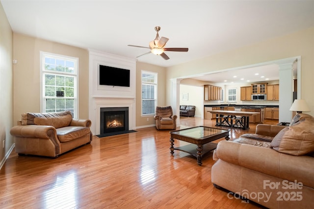 4201 Amber Leigh Way Dr, Charlotte, NC 28269 - living area featuring light wood-type flooring, ceiling fan, and a large fireplace