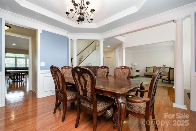 4201 Amber Leigh Way Dr, Charlotte, NC 28269 - dining area featuring ornate columns, light wood-type flooring, crown molding, and a chandelier