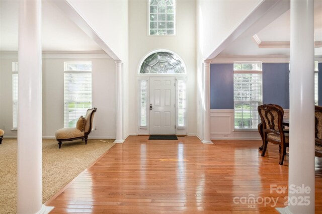 4201 Amber Leigh Way Dr, Charlotte, NC 28269 - entryway featuring decorative columns, light wood-style flooring, and ornamental molding