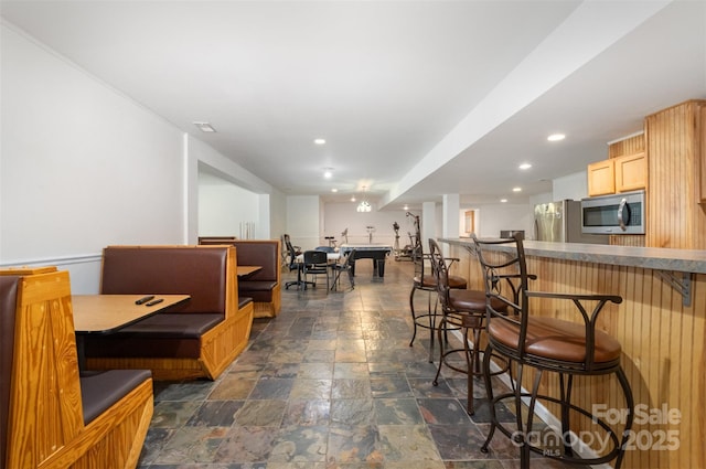 4201 Amber Leigh Way Dr, Charlotte, NC 28269 - dining area featuring dark stone finish flooring, a community bar, and recessed lighting
