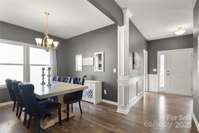 3212 Gilroy Dr, Fort Mill, SC 29707 - dining area with dark wood finished floors, a chandelier, decorative columns, and a wainscoted wall