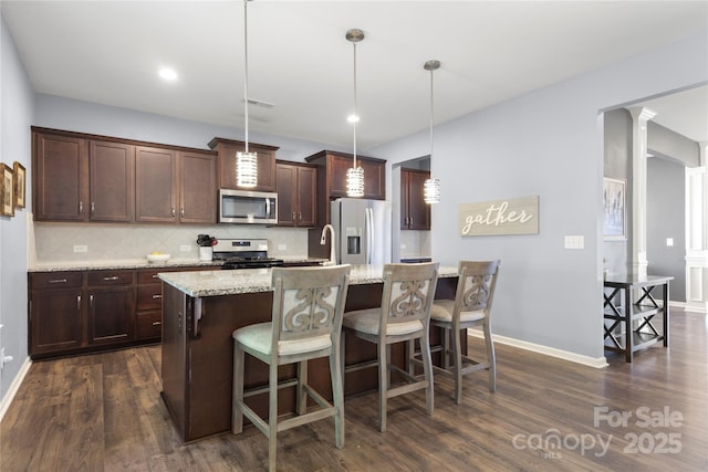 3212 Gilroy Dr, Fort Mill, SC 29707 - kitchen with stainless steel appliances, decorative backsplash, dark wood finished floors, dark brown cabinetry, and recessed lighting