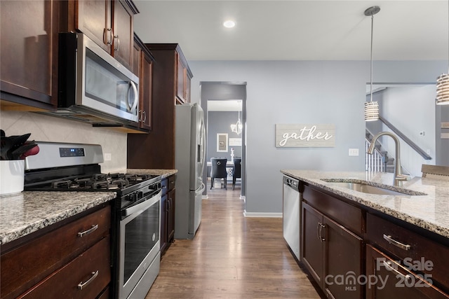 3212 Gilroy Dr, Fort Mill, SC 29707 - kitchen featuring appliances with stainless steel finishes, dark wood-style flooring, decorative backsplash, light stone counters, and dark brown cabinetry