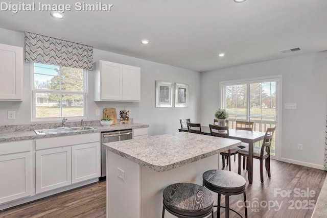 10127 Florentine Way, Charlotte, NC 28214 - kitchen featuring dishwasher, a sink, dark wood-style floors, white cabinetry, and recessed lighting