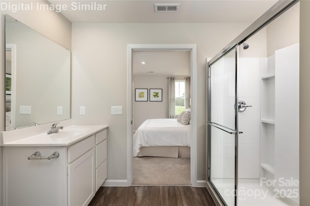 10127 Florentine Way, Charlotte, NC 28214 - ensuite bathroom with wood finished floors, vanity, a shower stall, and baseboards