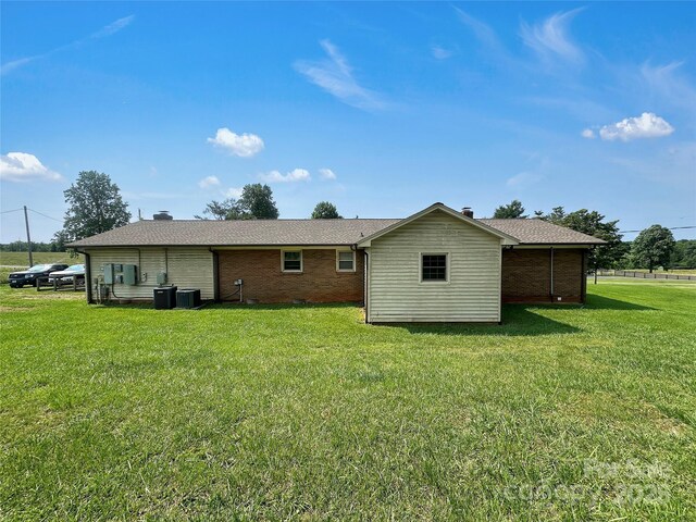 305 Rockdale Rd, Lawndale, NC 28090 - back of property featuring brick siding, a lawn, and a chimney
