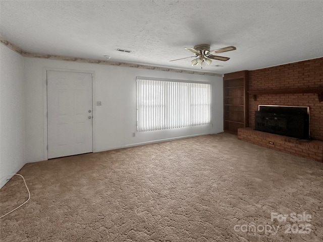 305 Rockdale Rd, Lawndale, NC 28090 - unfurnished living room featuring a textured ceiling, ceiling fan, carpet, a fireplace, and built in features
