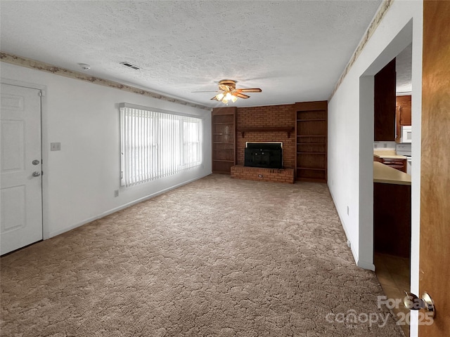 305 Rockdale Rd, Lawndale, NC 28090 - unfurnished living room with ceiling fan, a textured ceiling, carpet, a fireplace, and built in shelves