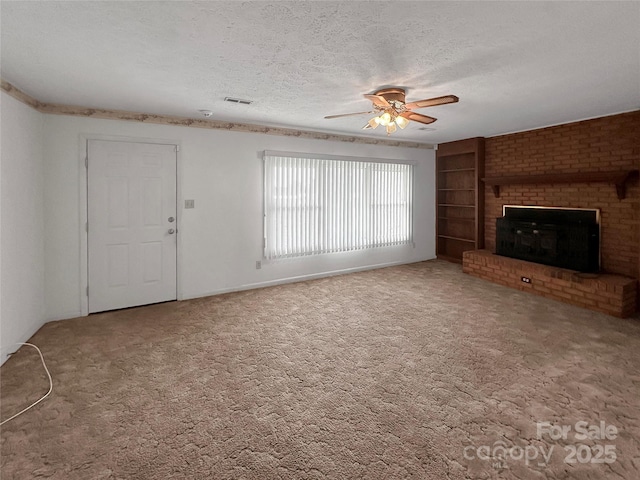 305 Rockdale Rd, Lawndale, NC 28090 - unfurnished living room with a ceiling fan, a textured ceiling, carpet floors, built in shelves, and a brick fireplace
