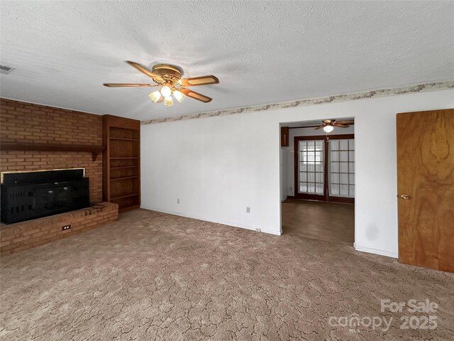 305 Rockdale Rd, Lawndale, NC 28090 - unfurnished living room featuring a ceiling fan, a textured ceiling, carpet floors, and a brick fireplace