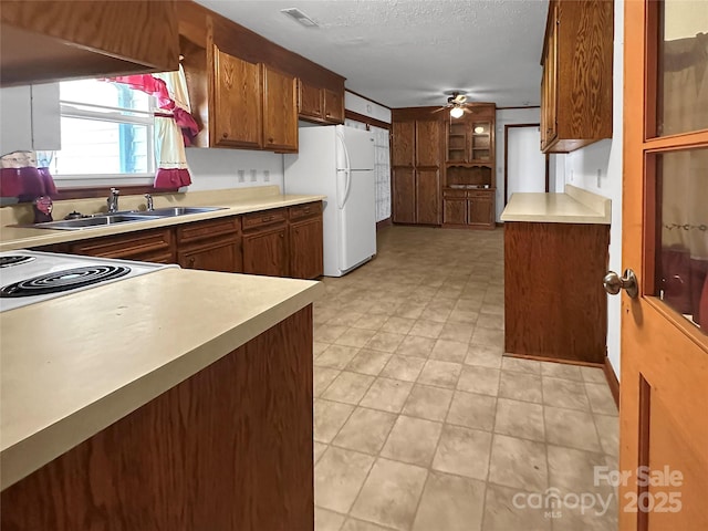305 Rockdale Rd, Lawndale, NC 28090 - kitchen with white appliances, light countertops, ceiling fan, under cabinet range hood, and brown cabinets