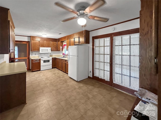 305 Rockdale Rd, Lawndale, NC 28090 - kitchen featuring white appliances, light flooring, a ceiling fan, light countertops, and brown cabinets