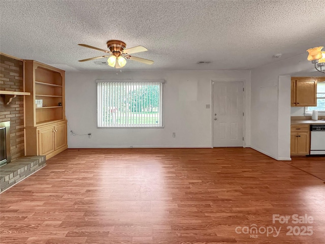 305 Rockdale Rd, Lawndale, NC 28090 - unfurnished living room with ceiling fan, light wood finished floors, a textured ceiling, and a fireplace