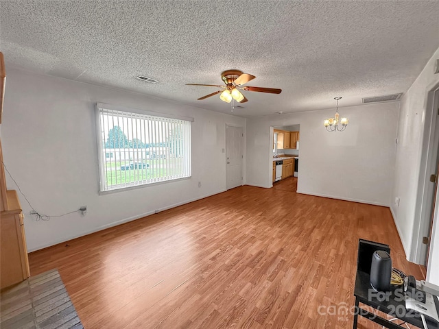 305 Rockdale Rd, Lawndale, NC 28090 - unfurnished living room with a chandelier, light wood finished floors, ceiling fan, and a textured ceiling