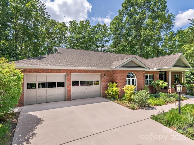 306 Croydon Dr, Hendersonville, NC 28791 - view of front facade featuring brick siding, an attached garage, driveway, and a shingled roof