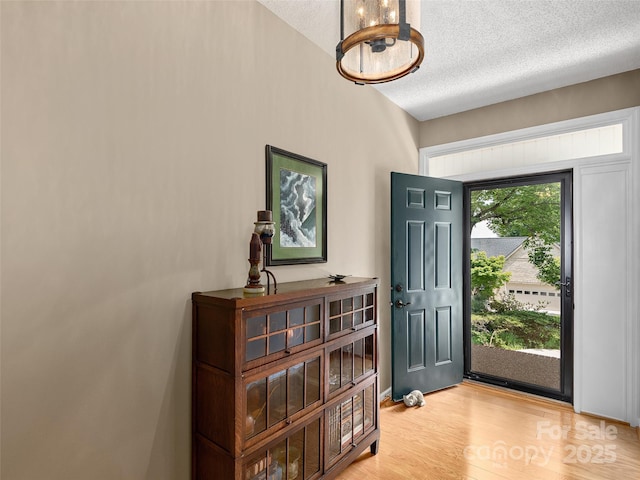 306 Croydon Dr, Hendersonville, NC 28791 - foyer with a textured ceiling, light wood-style floors, and a chandelier