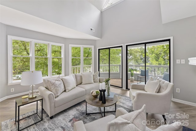 303 NW Dr, Davidson, NC 28036 - living room with baseboards, wood finished floors, and a high ceiling