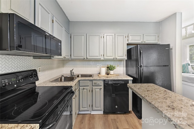 303 NW Dr, Davidson, NC 28036 - kitchen featuring black appliances, light wood-style flooring, backsplash, and a sink