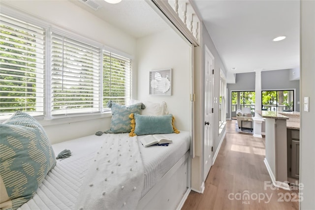303 NW Dr, Davidson, NC 28036 - bedroom featuring multiple windows, light wood-style flooring, and recessed lighting