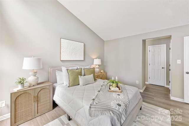303 NW Dr, Davidson, NC 28036 - bedroom featuring wood finished floors, baseboards, and lofted ceiling