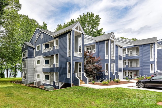303 NW Dr, Davidson, NC 28036 - view of property exterior with central AC unit, a lawn, and a balcony