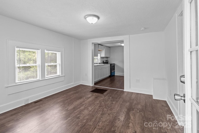 103 Garfield Ave, Albemarle, NC 28001 - interior space featuring a textured ceiling, dark wood-style floors, a sink, and baseboards