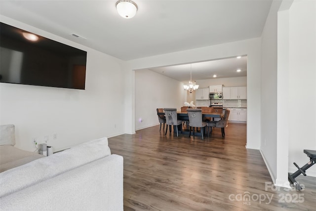 4013 Southern Pine Dr, Mount Holly, NC 28120 - dining area with wood finished floors, a chandelier, baseboards, and recessed lighting