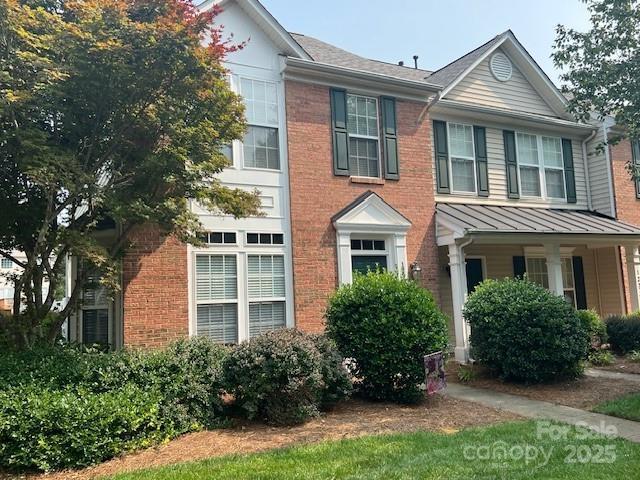 12378 Swan Wings Pl, Huntersville, NC 28078 - view of front of home featuring brick siding, a standing seam roof, and metal roof