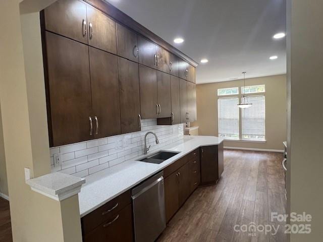 12378 Swan Wings Pl, Huntersville, NC 28078 - kitchen with a sink, dishwasher, backsplash, wood finished floors, and light countertops