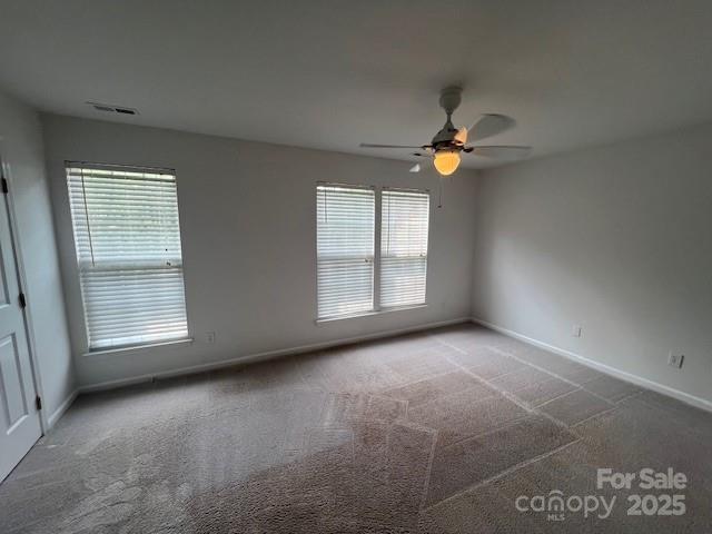12378 Swan Wings Pl, Huntersville, NC 28078 - spare room featuring carpet flooring, a ceiling fan, and baseboards