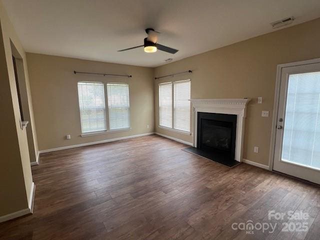12378 Swan Wings Pl, Huntersville, NC 28078 - unfurnished living room with a ceiling fan, wood finished floors, healthy amount of natural light, and baseboards
