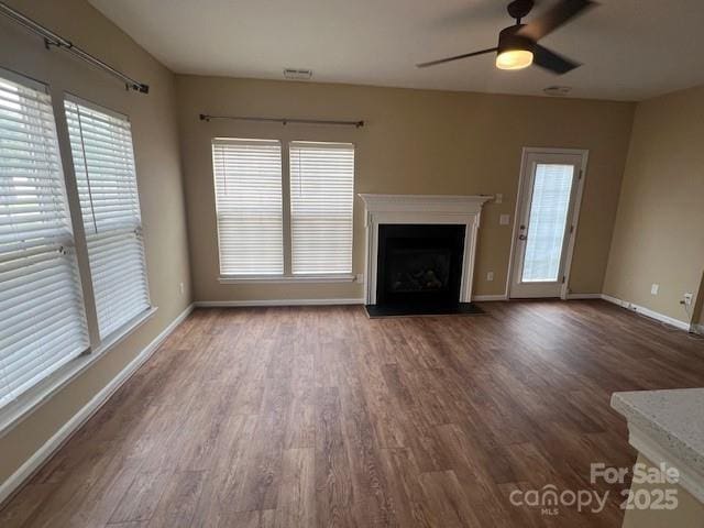 12378 Swan Wings Pl, Huntersville, NC 28078 - unfurnished living room with baseboards, wood finished floors, and healthy amount of natural light