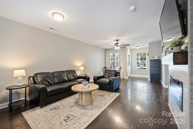 1925 Sandal Brook Rd, Indian Land, SC 29707 - living area with baseboards, a ceiling fan, dark wood-style flooring, and a fireplace