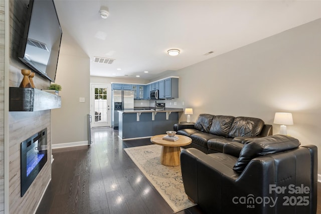 1925 Sandal Brook Rd, Indian Land, SC 29707 - living area featuring a glass covered fireplace, baseboards, dark wood-style floors, and recessed lighting