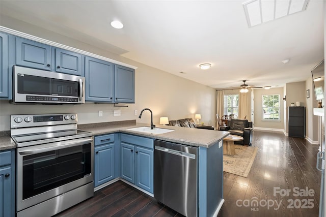 1925 Sandal Brook Rd, Indian Land, SC 29707 - kitchen featuring stainless steel appliances, a sink, a peninsula, blue cabinetry, and recessed lighting