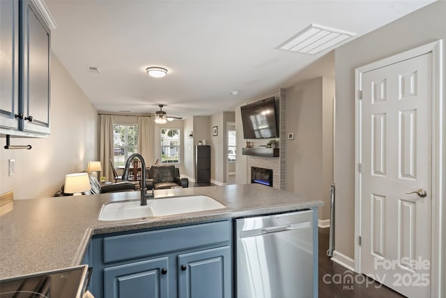 1925 Sandal Brook Rd, Indian Land, SC 29707 - kitchen featuring dishwasher, a sink, open floor plan, a peninsula, and a fireplace