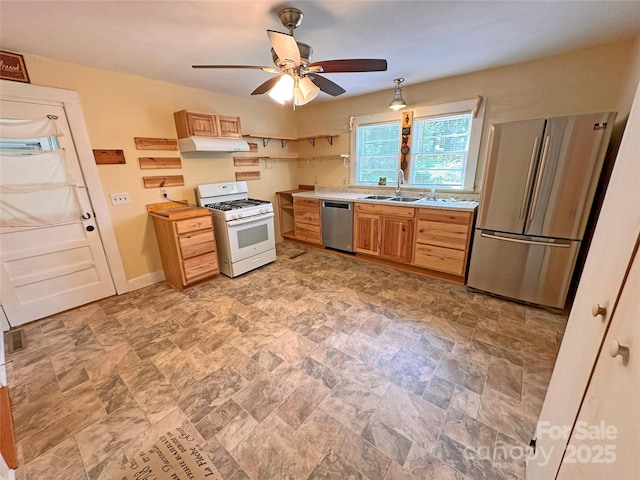 2131 E NC-10 Hwy, Conover, NC 28613 - kitchen featuring appliances with stainless steel finishes, a sink, under cabinet range hood, stone finish floors, and light countertops