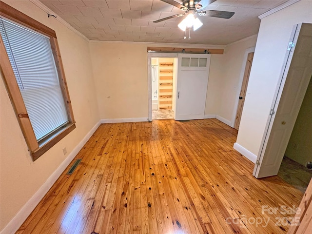 2131 E NC-10 Hwy, Conover, NC 28613 - unfurnished bedroom with crown molding, light wood finished floors, baseboards, and a ceiling fan