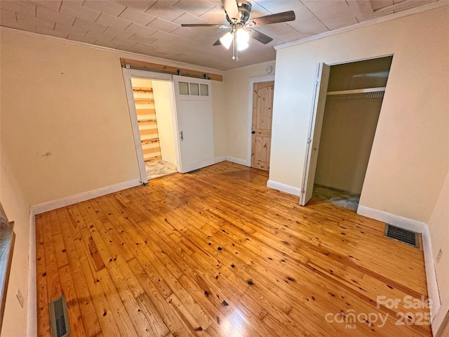 2131 E NC-10 Hwy, Conover, NC 28613 - unfurnished bedroom with ornamental molding, light wood finished floors, a closet, baseboards, and ceiling fan