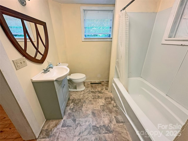 2131 E NC-10 Hwy, Conover, NC 28613 - full bathroom featuring vanity, toilet, stone finish flooring, baseboards, and plenty of natural light