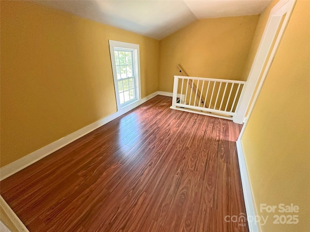 2131 E NC-10 Hwy, Conover, NC 28613 - unfurnished room with dark wood-type flooring, lofted ceiling, and baseboards